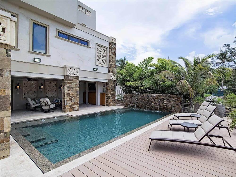 Dive Into This Outdoor Pool Area with Stylish Stone Accents