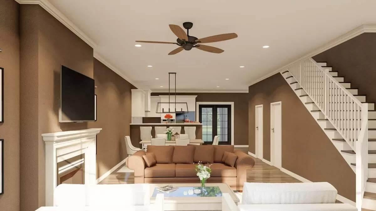 Open-Concept Living with a Cozy Fireplace and a Sleek Ceiling Fan