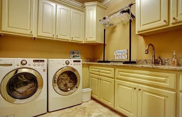 Laundry Room Highlights Abundant Cabinetry and Granite Countertop