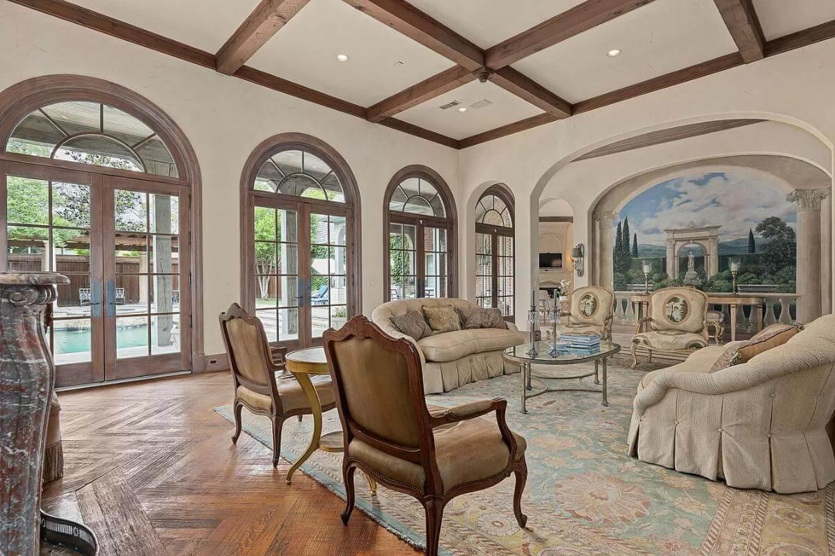 Elegant Living Room with Arched Windows and a Captivating Mural