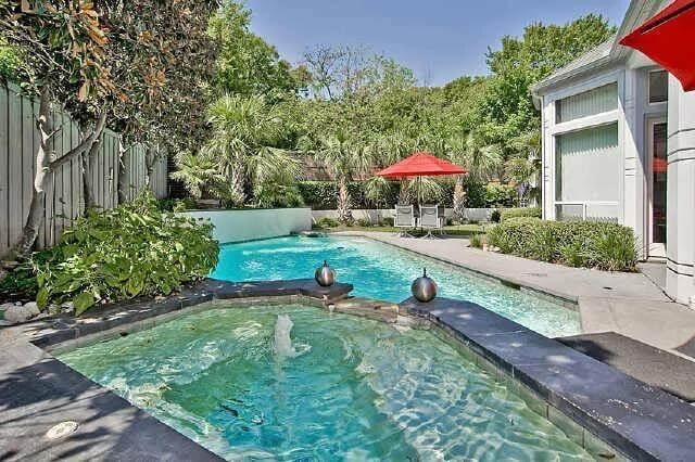 Dive into This Backyard Oasis with Vibrant Red Umbrellas