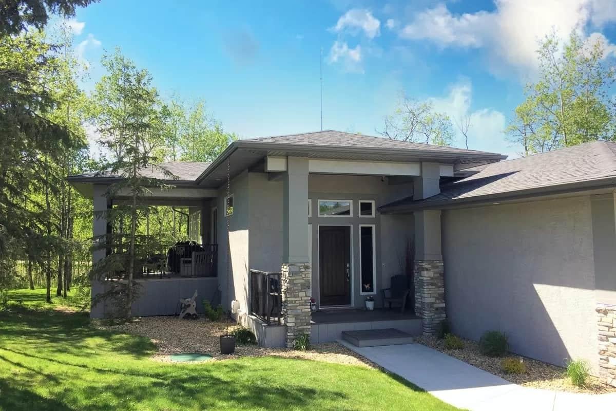 Notice the Modern Entryway Framed by Bold Stone Columns