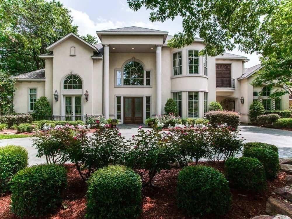 Grand Entrance Flanked by Elegant Arched Windows