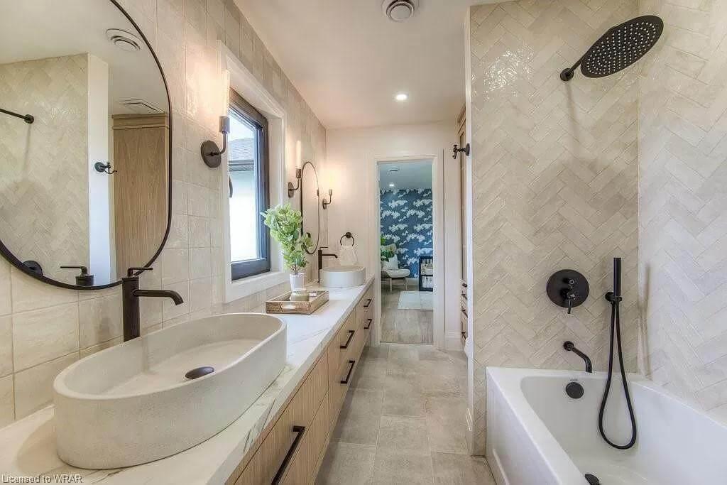Luxurious Bathroom with Oval Vessel Sinks and Bold Black Fixtures