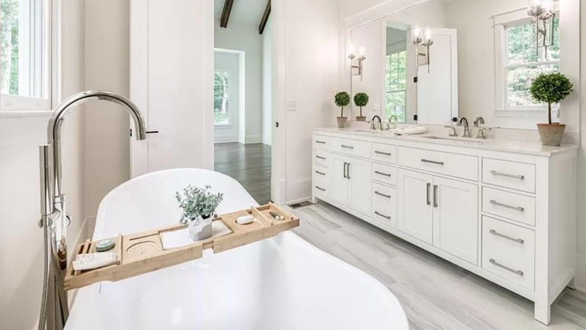 Freestanding Tub Oasis with Elegant Dual Vanity and Pops of Green