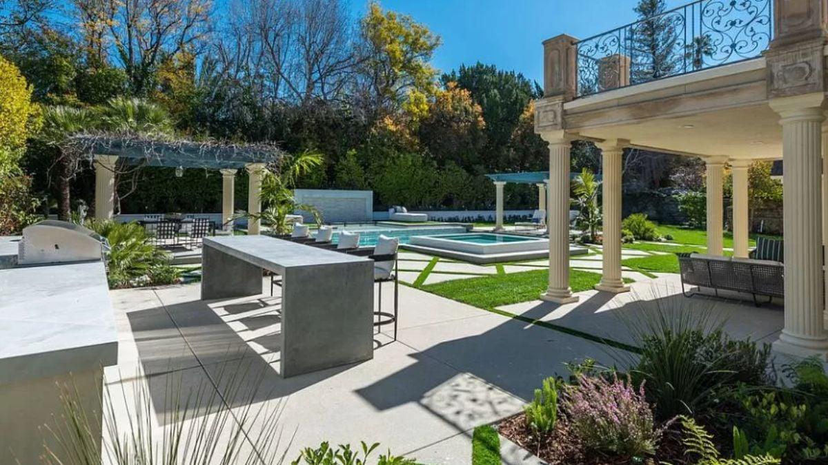 Stunning Outdoor Living Space Featuring a Grill and Bar for Entertaining