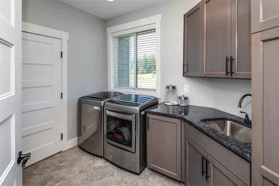 Efficient Laundry Room Featuring a Stylish Granite Counter