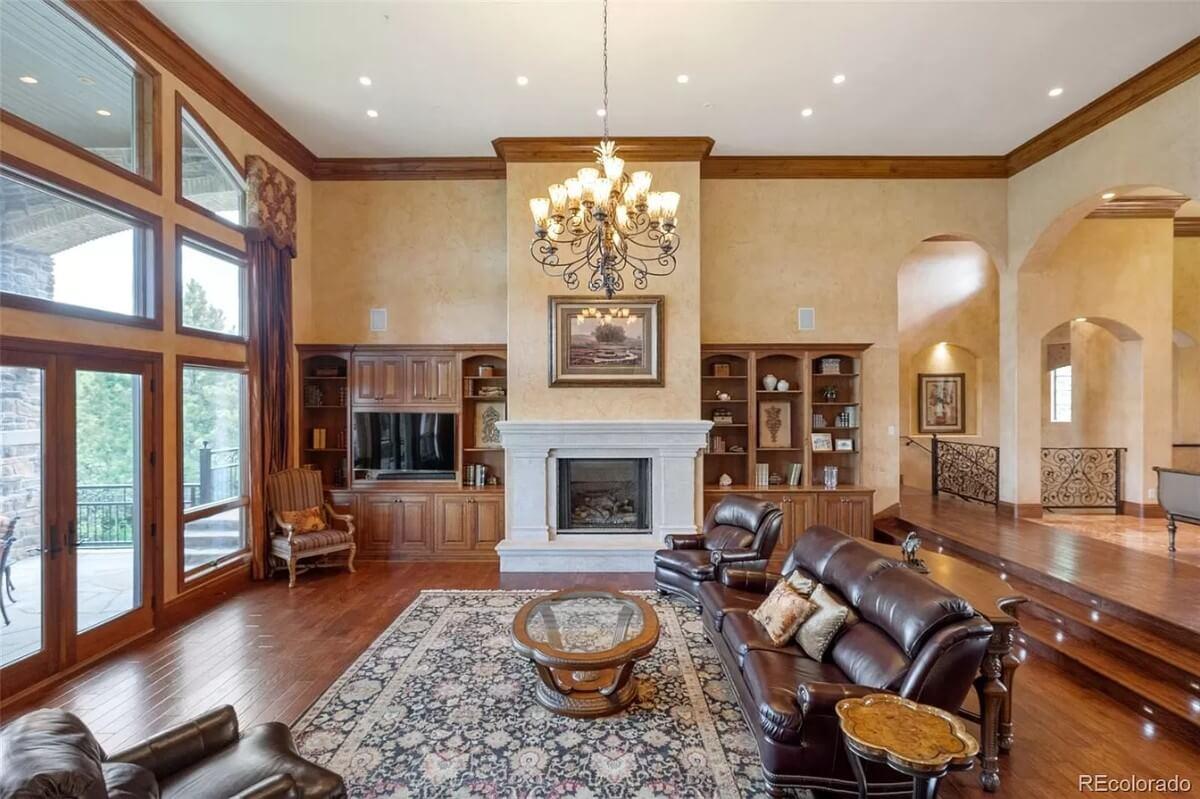 Opulent Living Room With a Striking Chandelier and Rich Wood Accents