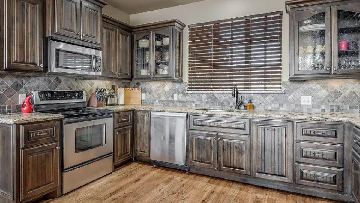 Classic Wooden Cabinetry and a Textured Stone Backsplash