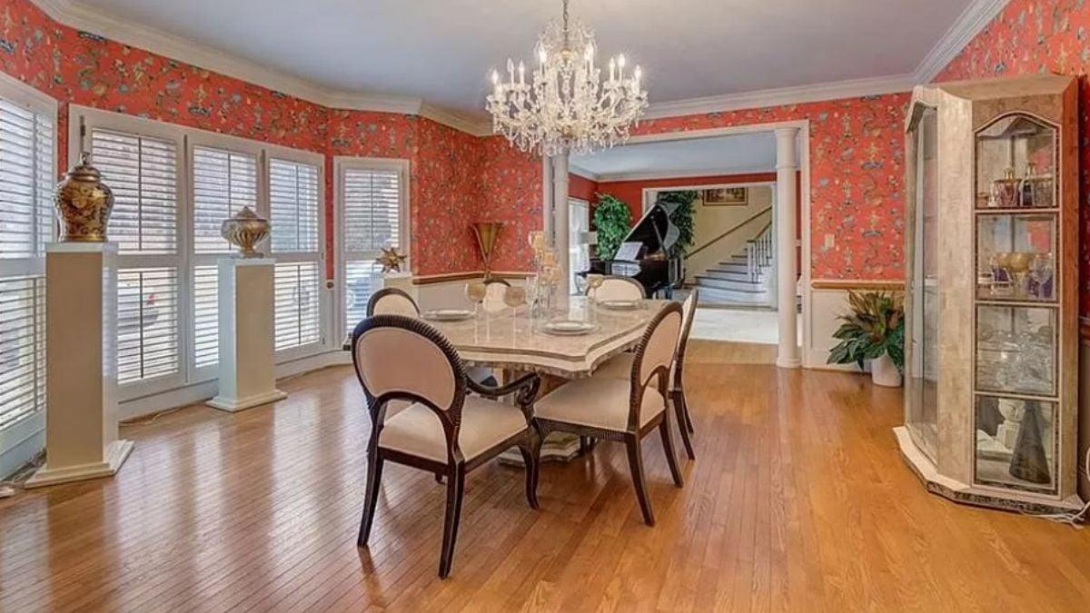 Formal Dining Room with Eye-Catching Floral Wallpaper and a Grand Chandelier