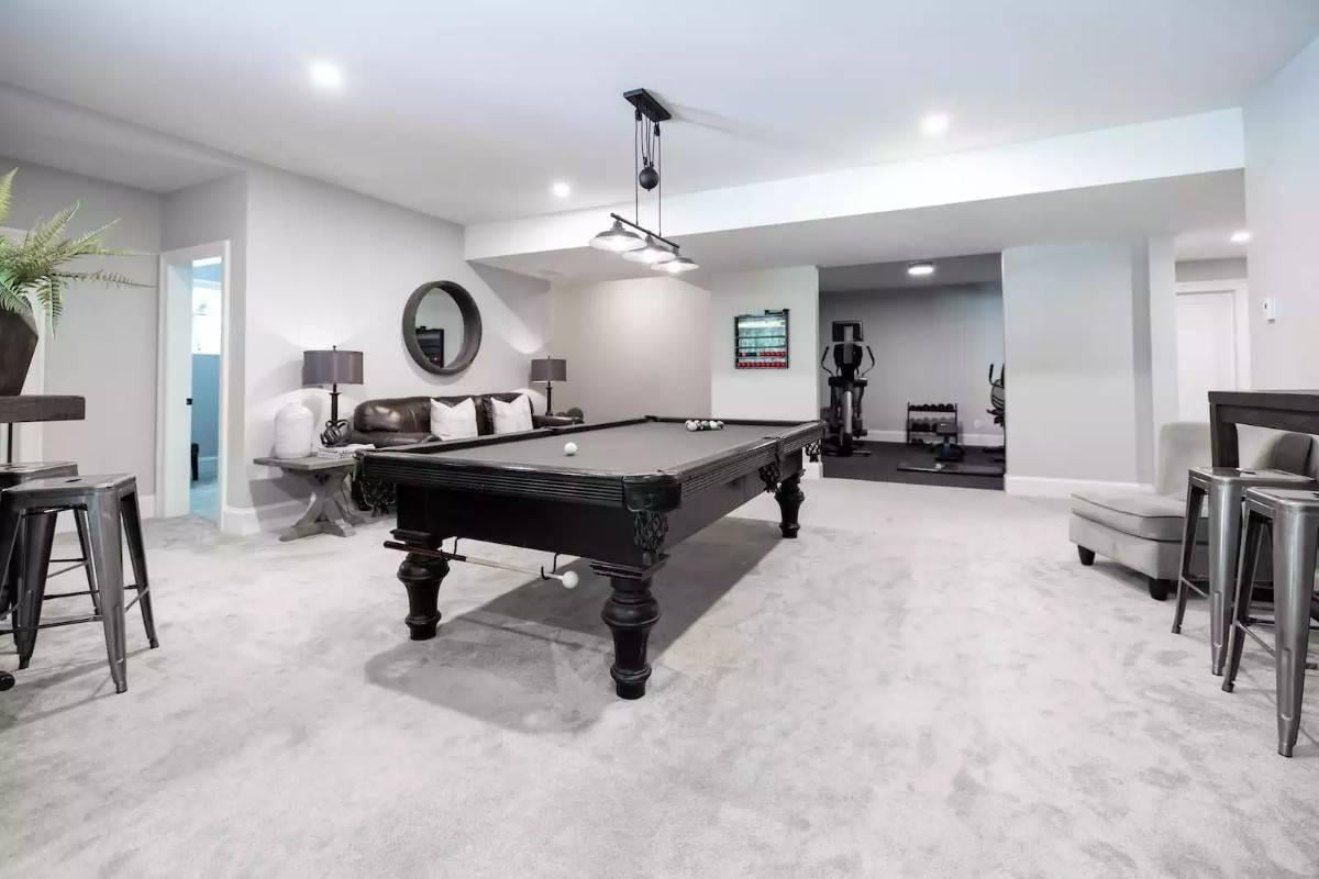 Enjoy Game and Relaxation Zones in This Versatile Basement