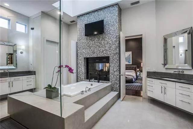 Luxurious Bathroom Featuring a Striking Tiled Fireplace