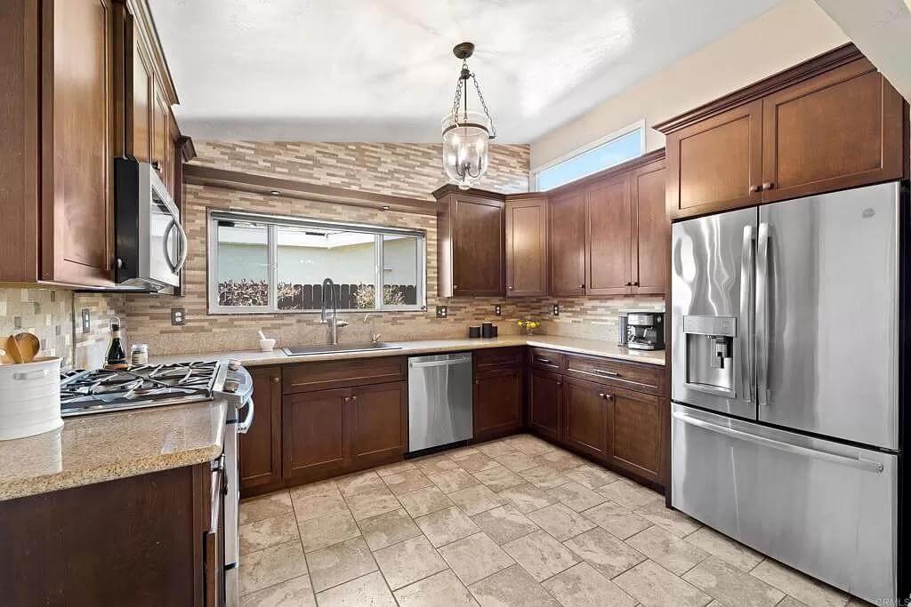Notice the Warm Wood Cabinetry and Modern Stainless Steel Appliances