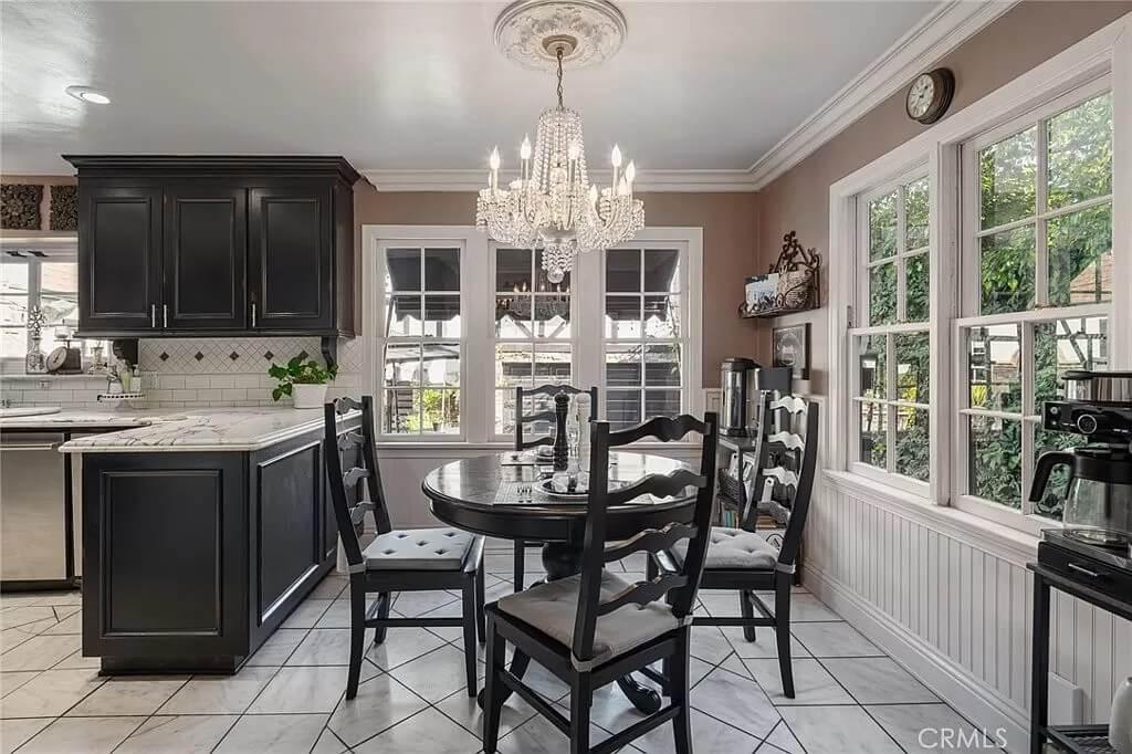 Charming Breakfast Nook with Elegant Chandelier and Classic Black Chairs