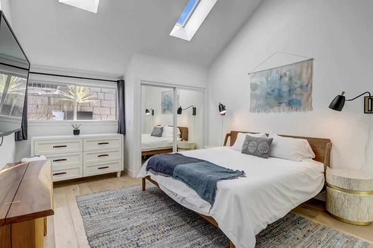 Bright Bedroom with Skylights and a Touch of Cozy Artwork