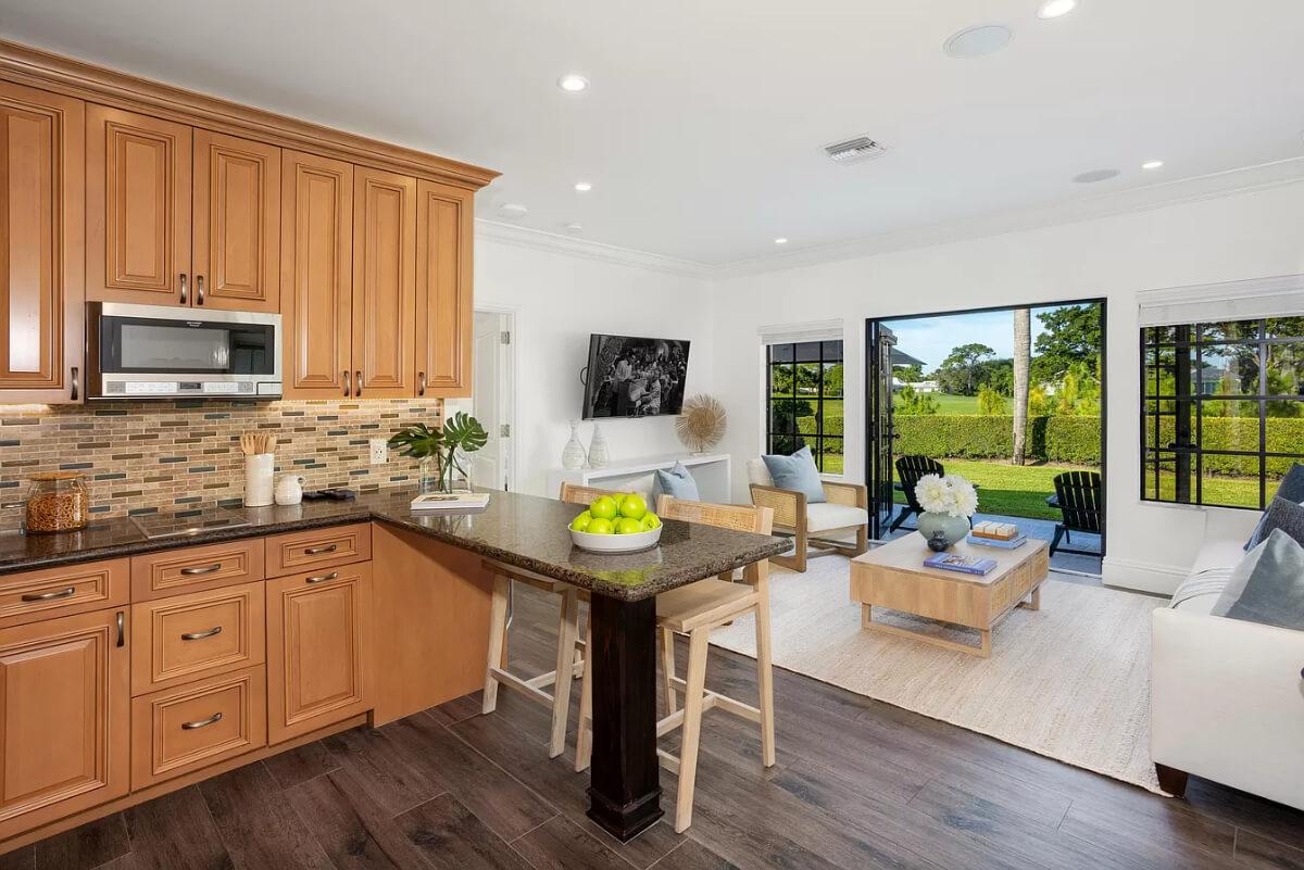 Open Layout Highlighted by Warm Wood Cabinetry and Outdoor Views