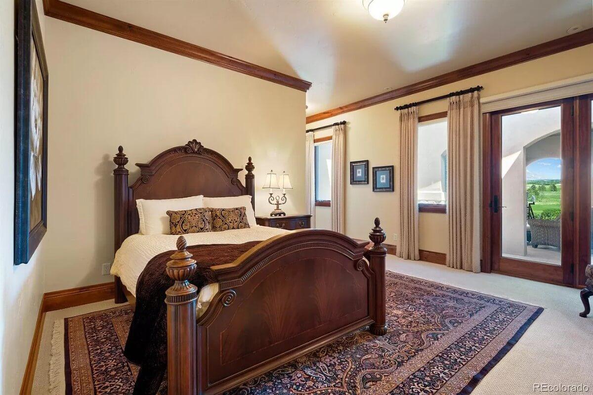 Admire the Ornate Four-Poster Bed in This Spacious Bedroom