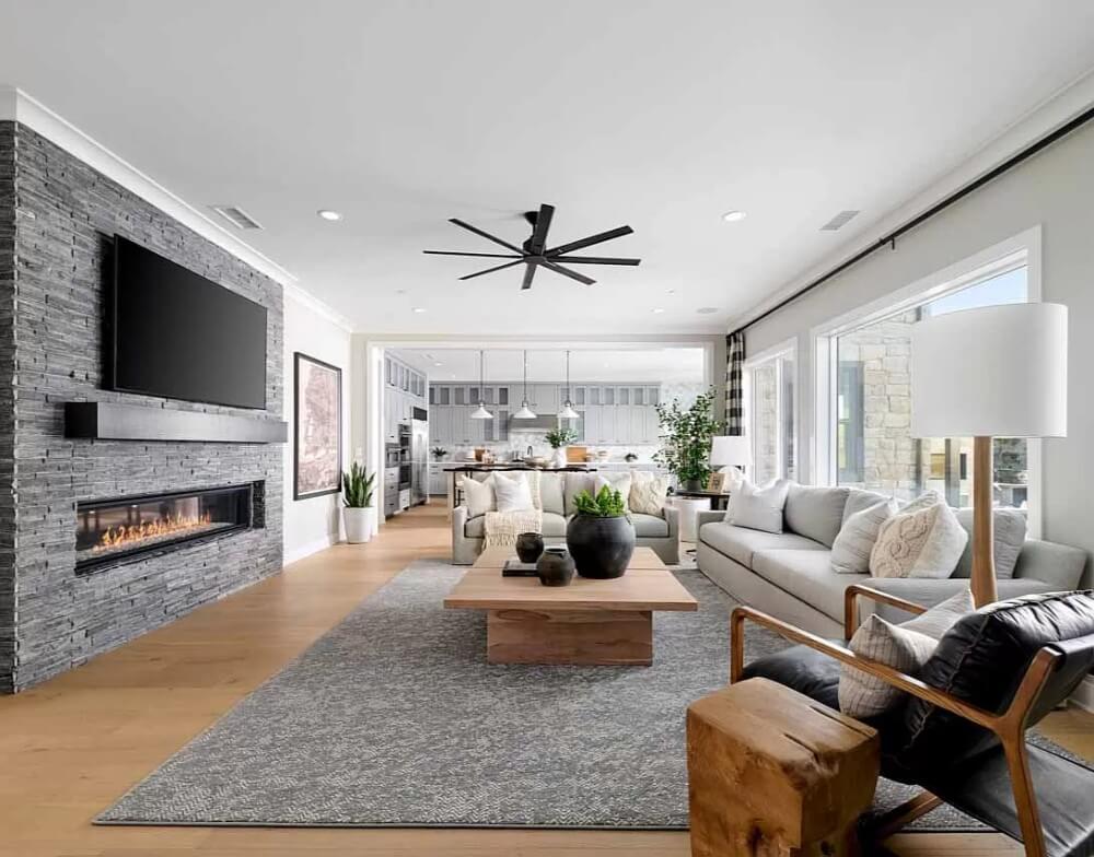 Modern Living Room with Sleek Stone Fireplace and Expansive Windows