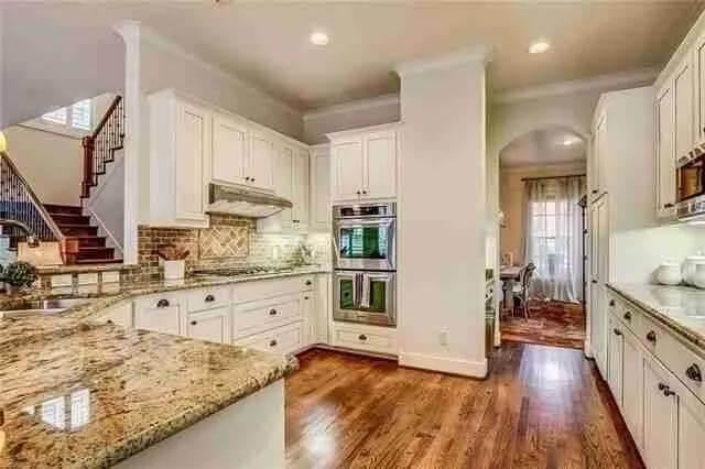 Spacious Kitchen with Granite Countertops and a Charming Breakfast Nook