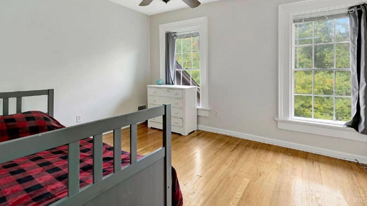 Simple Bedroom with Large Windows and Hardwood Floors