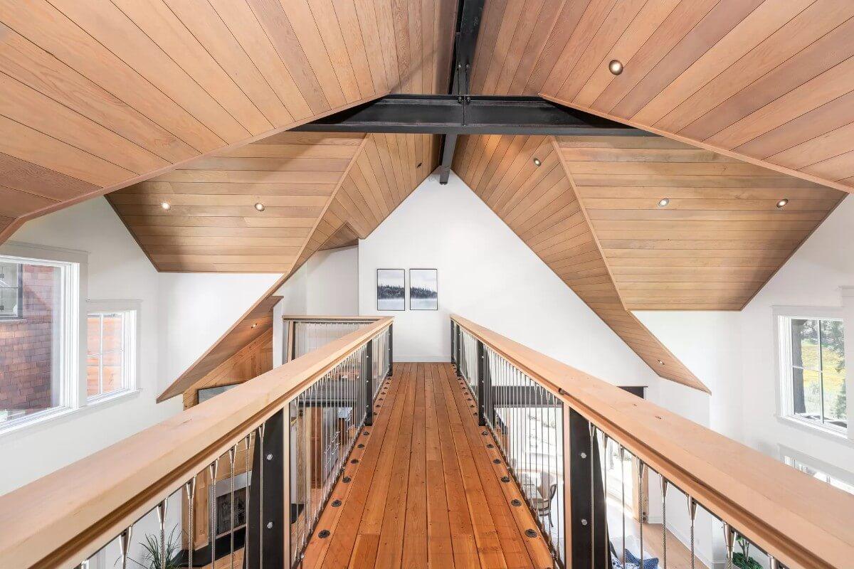 A Lofty Walkway with Exposed Rafters Makes a Dramatic Statement