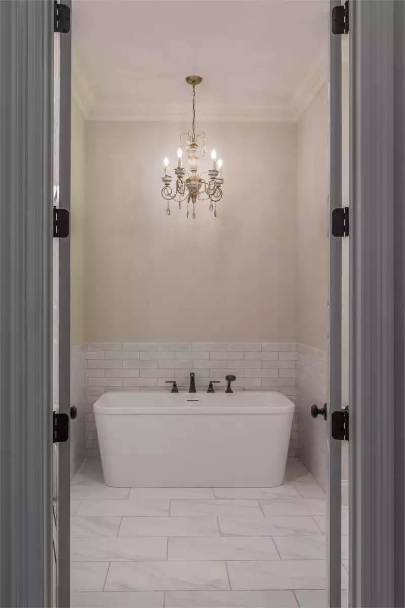 Take a Peek at This Luxurious Freestanding Tub Under a Classic Chandelier