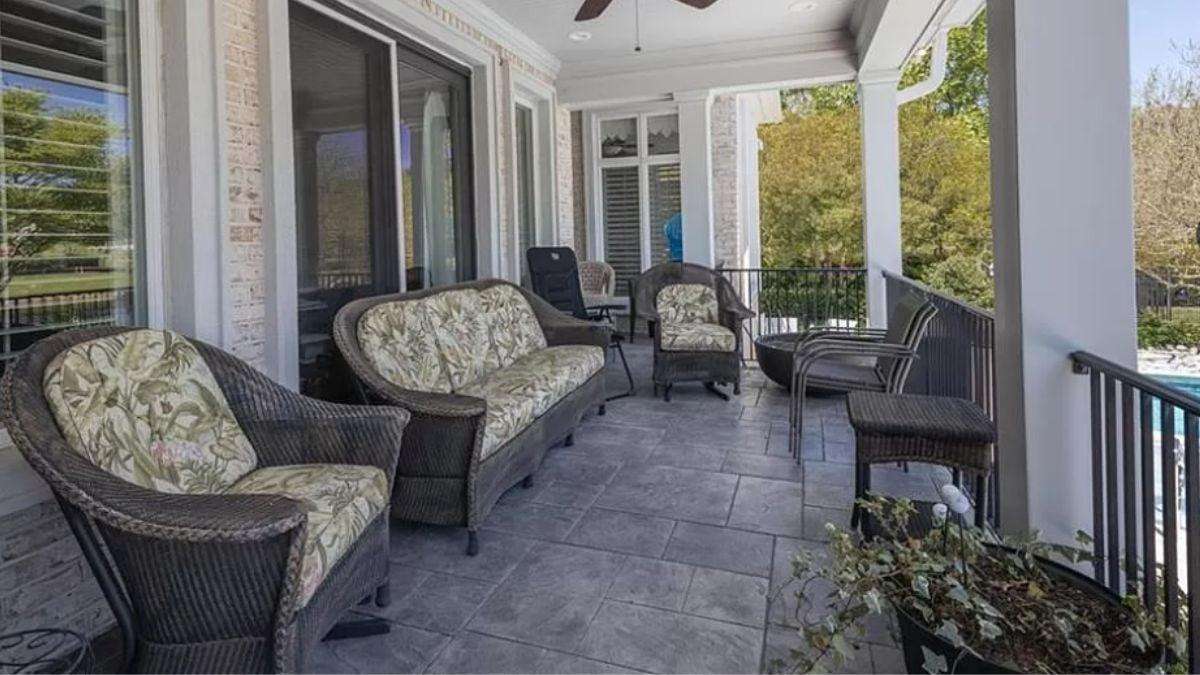 Charming Patio with Wicker Seating and Lush Green Views
