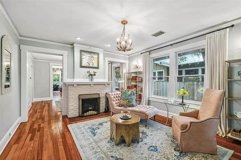 Elegantly Crafted Living Room with a Decorative Fireplace and Antique Charm