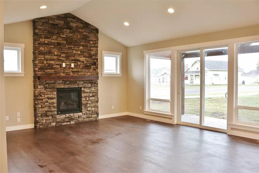 Vaulted Ceiling Living Room with a Striking Stone Fireplace