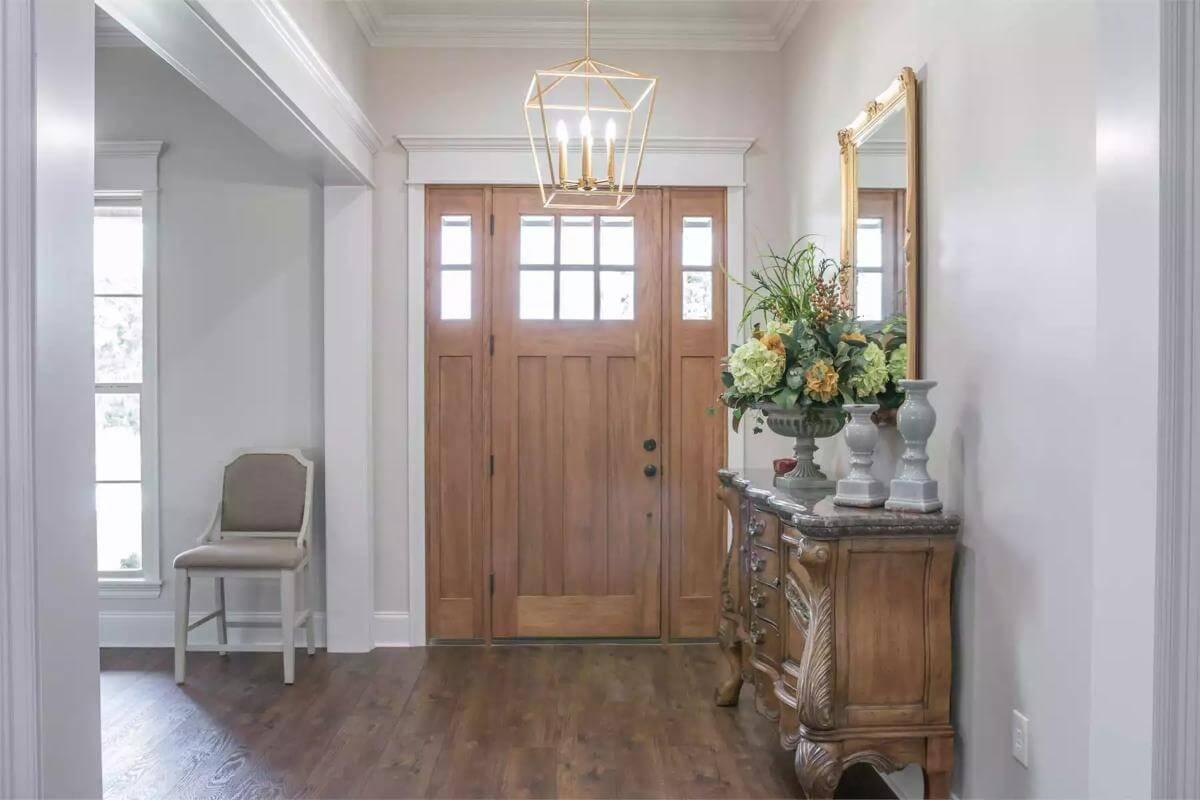 Notice the Elegant Wooden Front Door Paired with a Chic Pendant Light