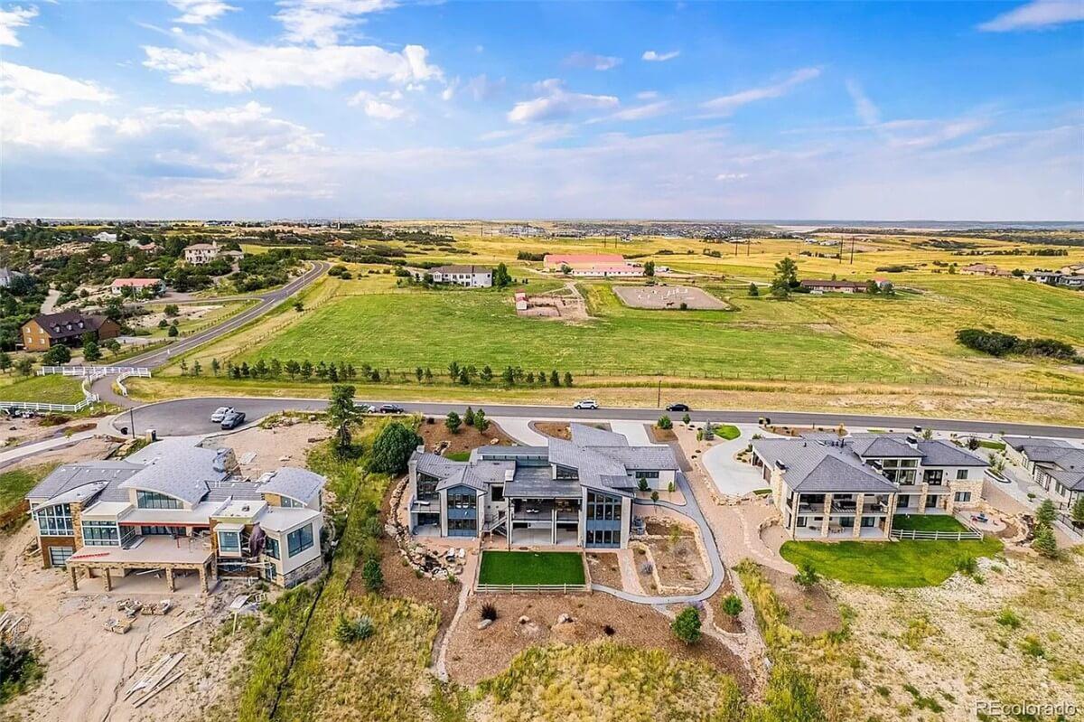 Aerial View Showcases Modern Homes Amidst Expansive Landscapes