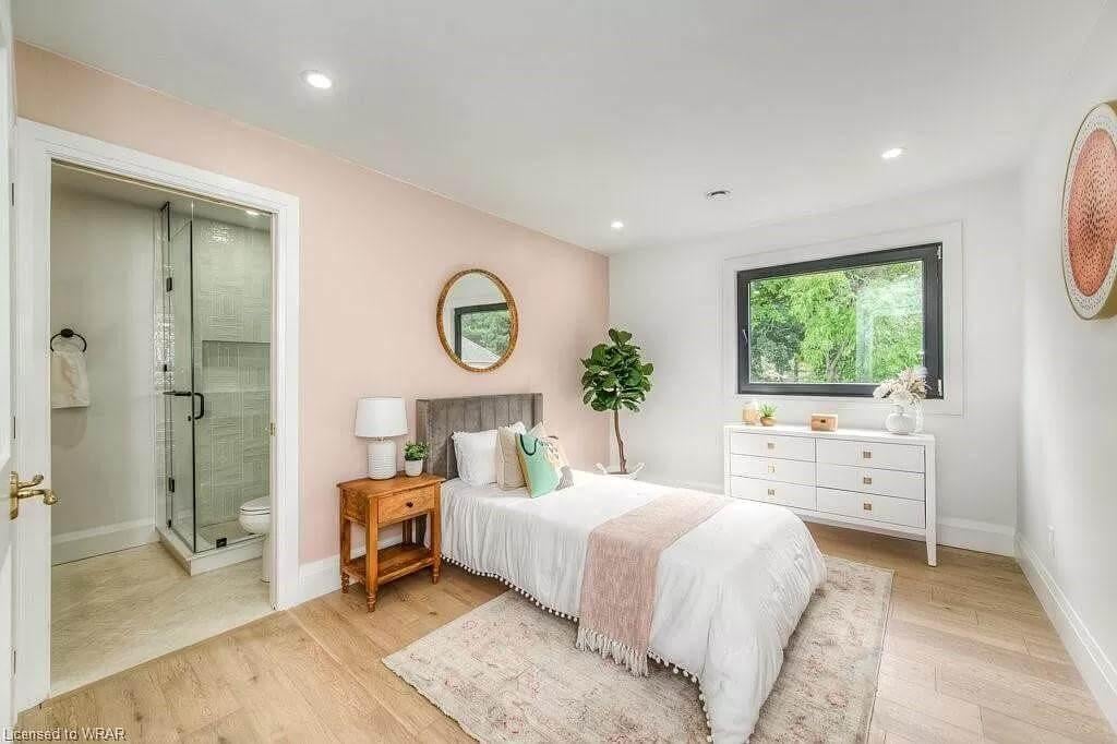 Chic Bedroom with Subtle Pink Accent Wall and Modern Window