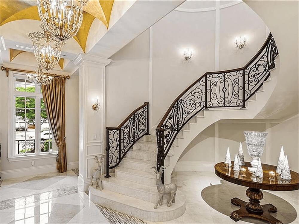 Grand Staircase with Intricate Ironwork and Gilded Ceilings