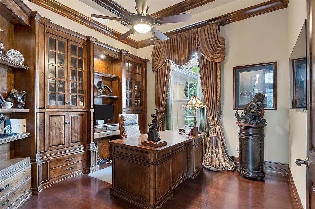 Check Out This Elegant Home Office With Rich Wood Built-Ins