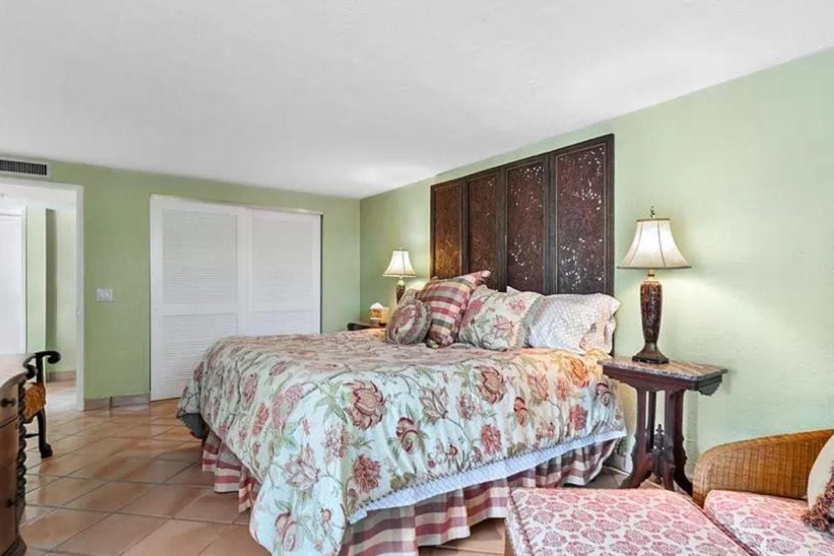 Admire the Floral Theme and Unique Headboard in This Bedroom