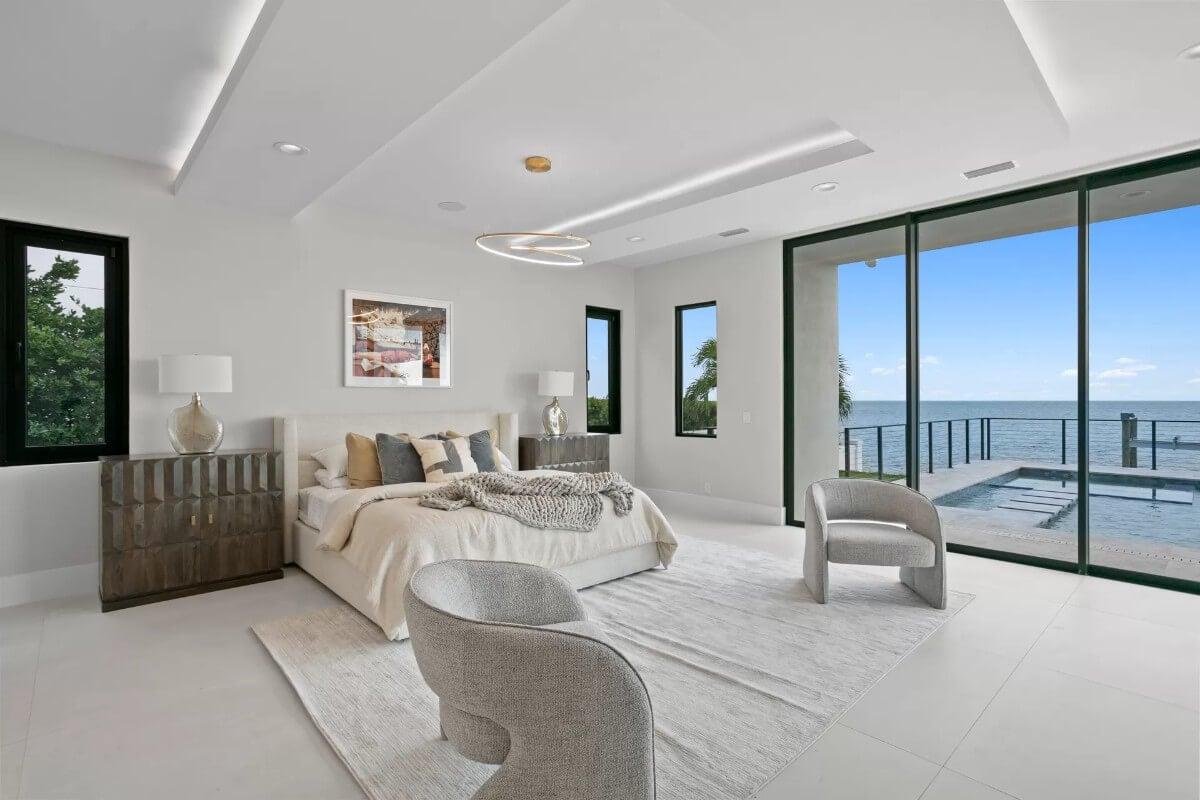 Tranquil Bedroom with Mesmerizing Ocean Views and a Unique Light Fixture