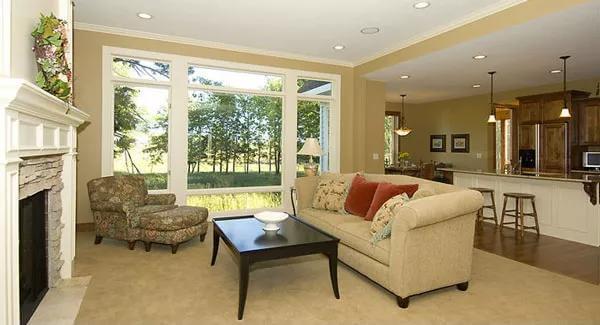 Open Living Space with Expansive Windows and Seamless Kitchen Access