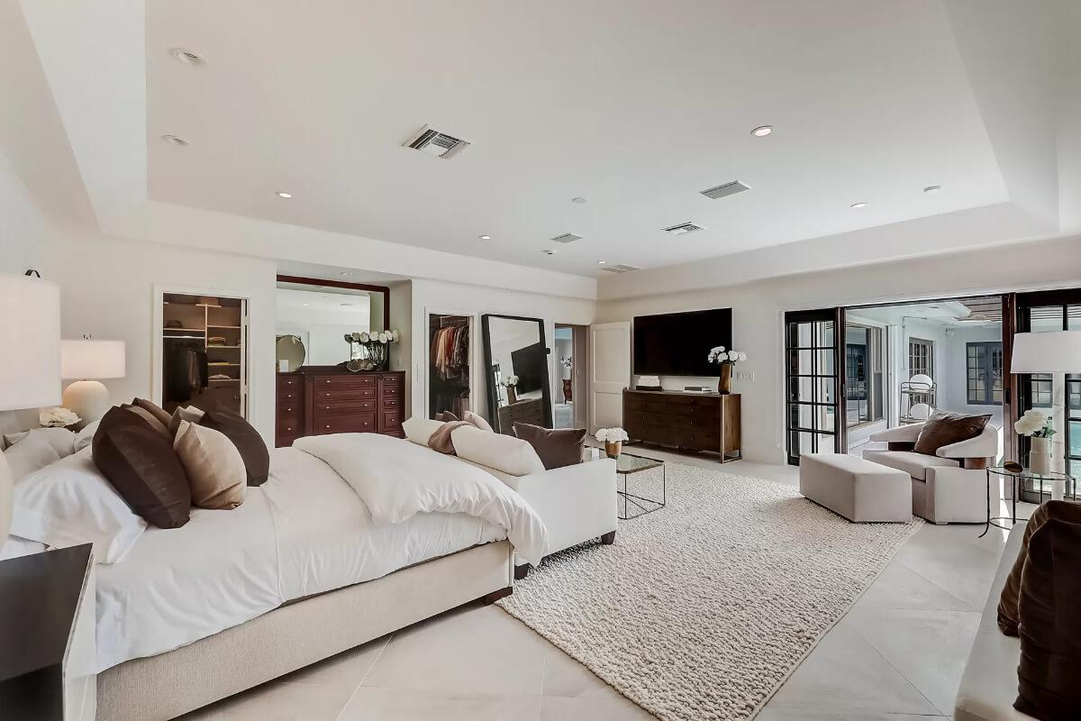Unwind in This Luxurious Master Suite with Poolside Views