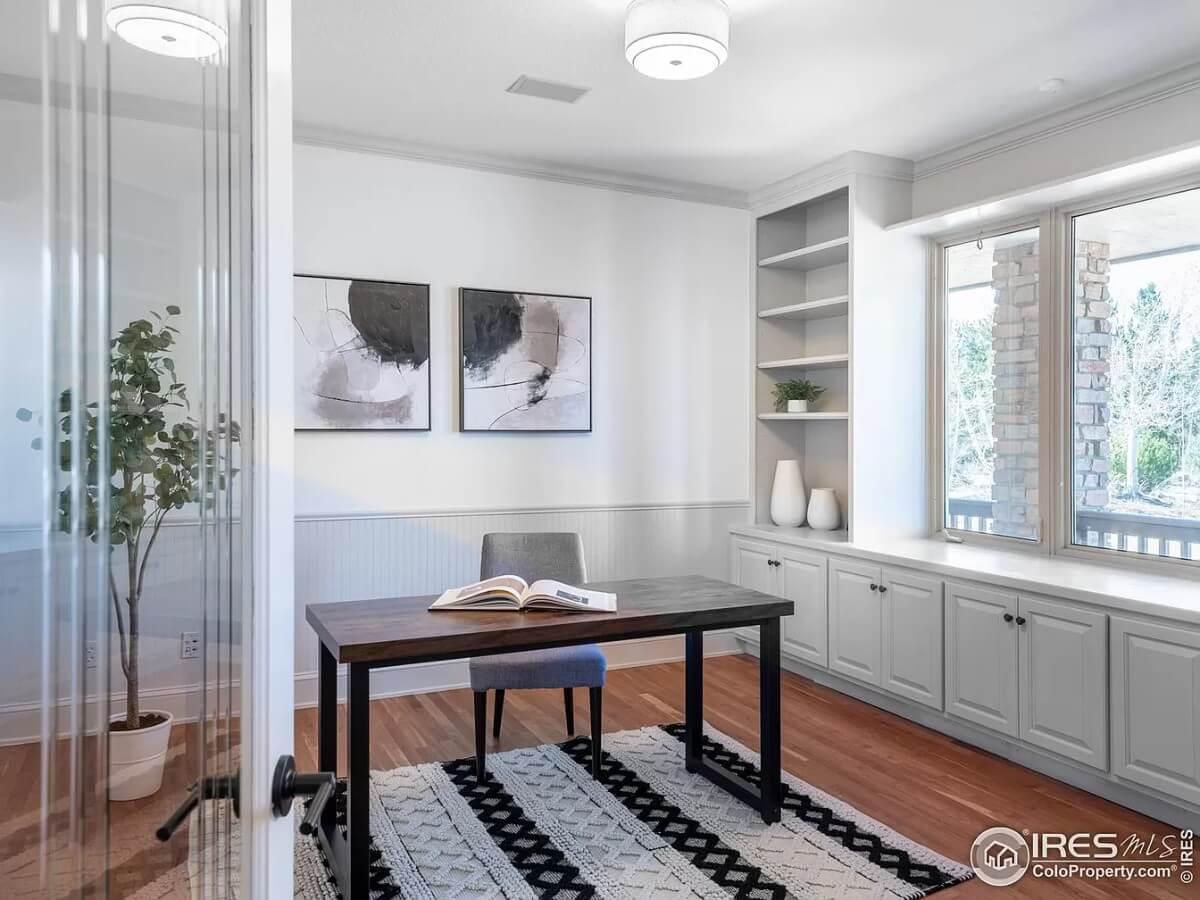 Home Office with Built-In Shelving and a Bright Picture Window