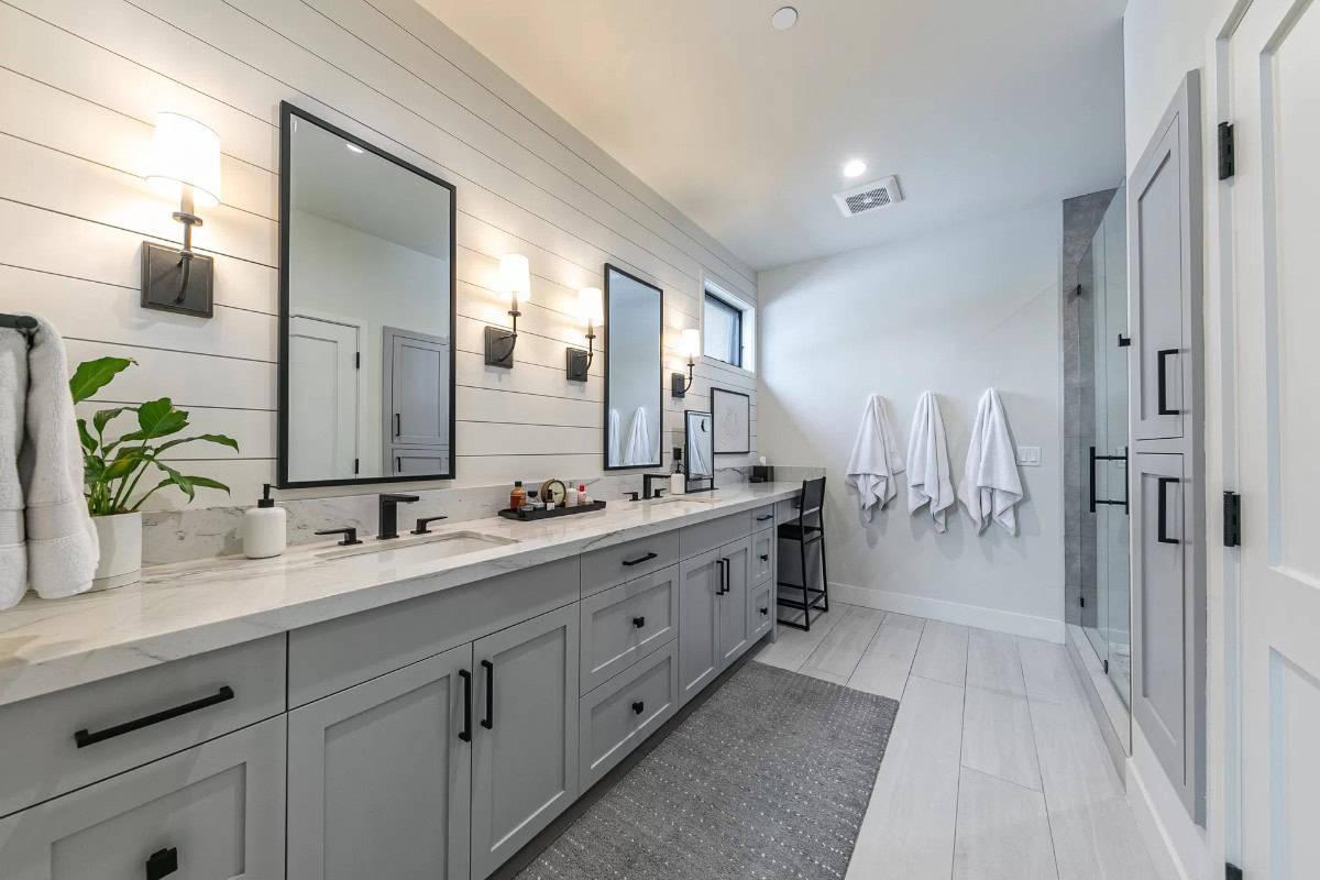 Explore the Dual Vanity Against a Shiplap Wall in This Sleek Bathroom