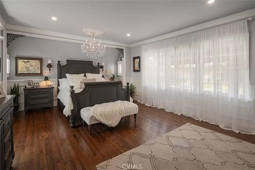 Elegant Bedroom Retreat with Ornate Headboard and Sheer Drapes