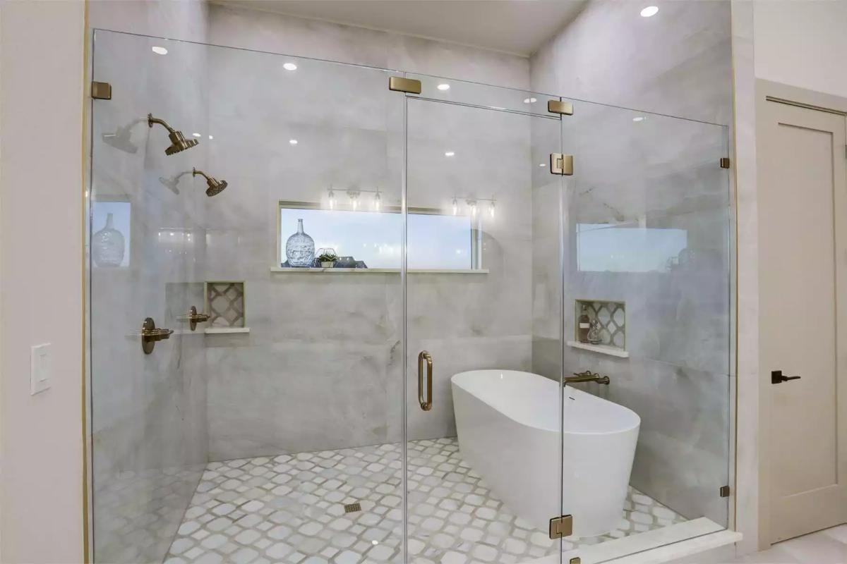 Expansive Glass-Enclosed Shower and Freestanding Tub in a Luxurious Bathroom