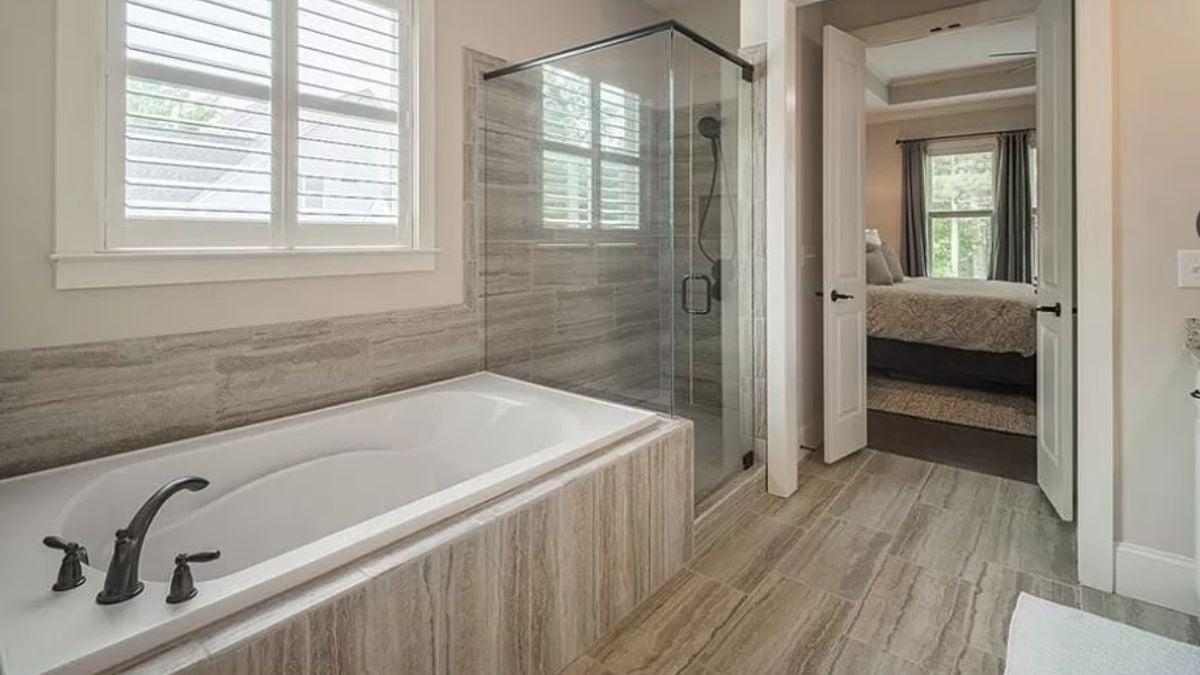 Discover the Relaxation Oasis with This Soaking Tub and Glass Shower