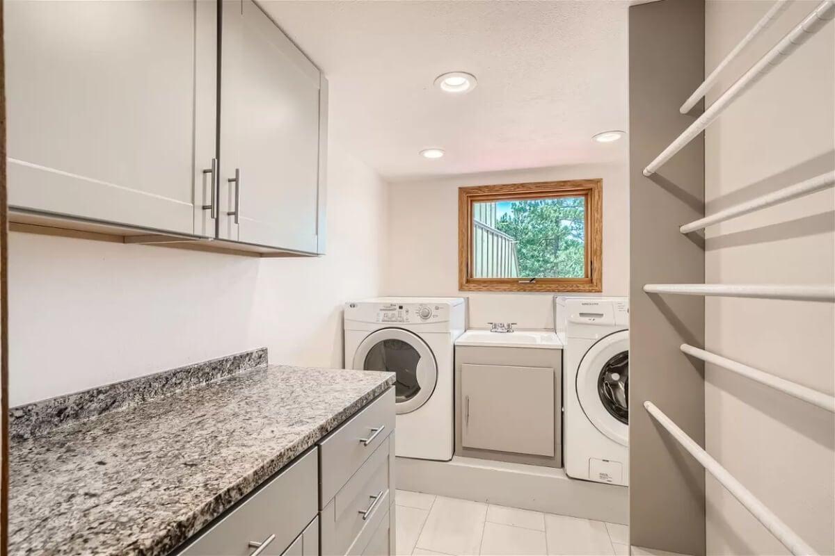 Check Out the Granite Countertops in This Well-Organized Laundry Room