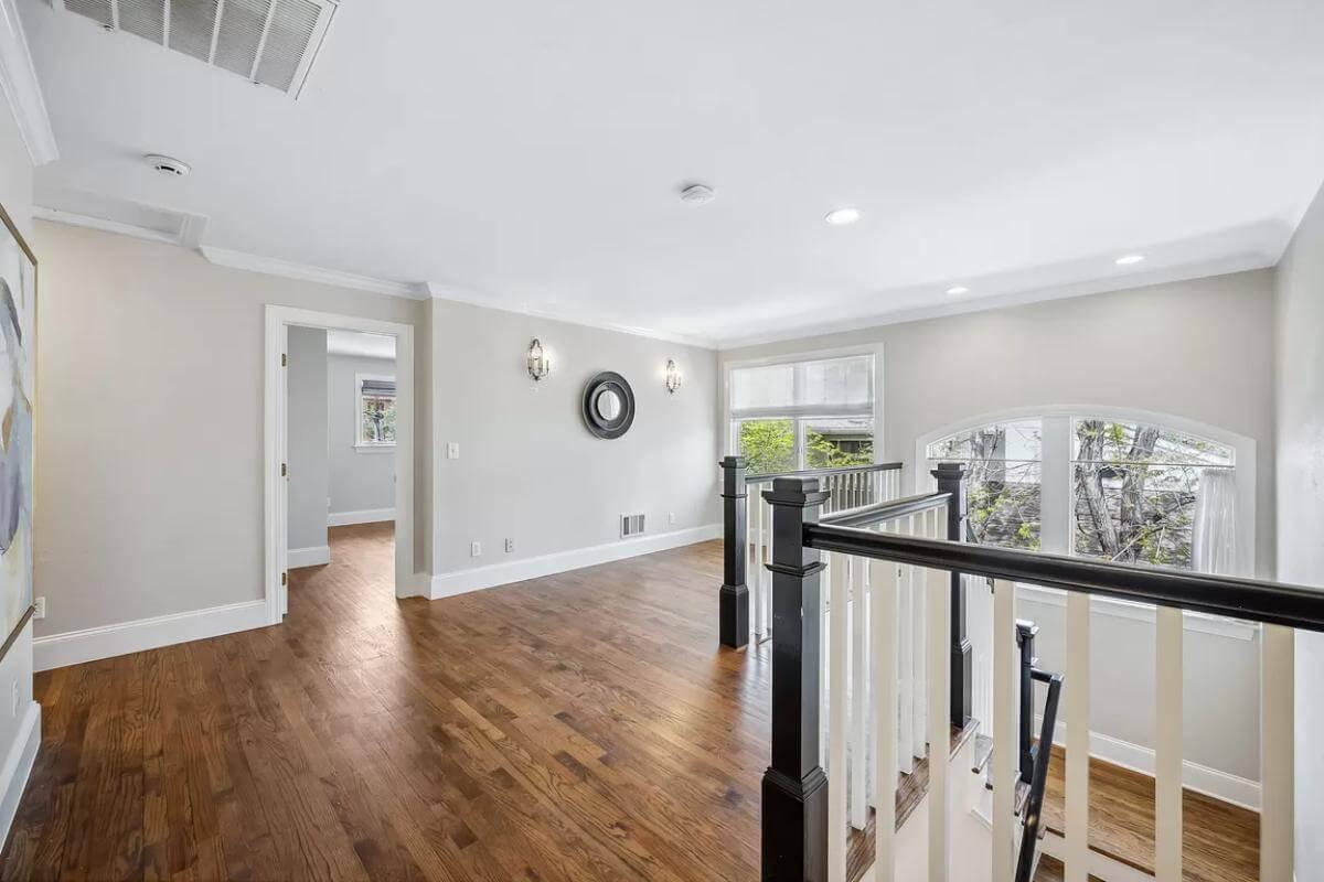 Take a Look at These Dark Hardwood Floors and Classic Railing