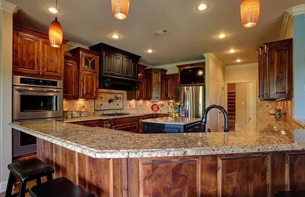 Rich Wooden Cabinetry in a Classic Kitchen Setting With Granite Surfaces