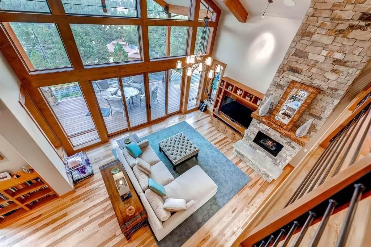 Wow, Look at the Huge Windows and Cozy Stone Fireplace in This Living Room