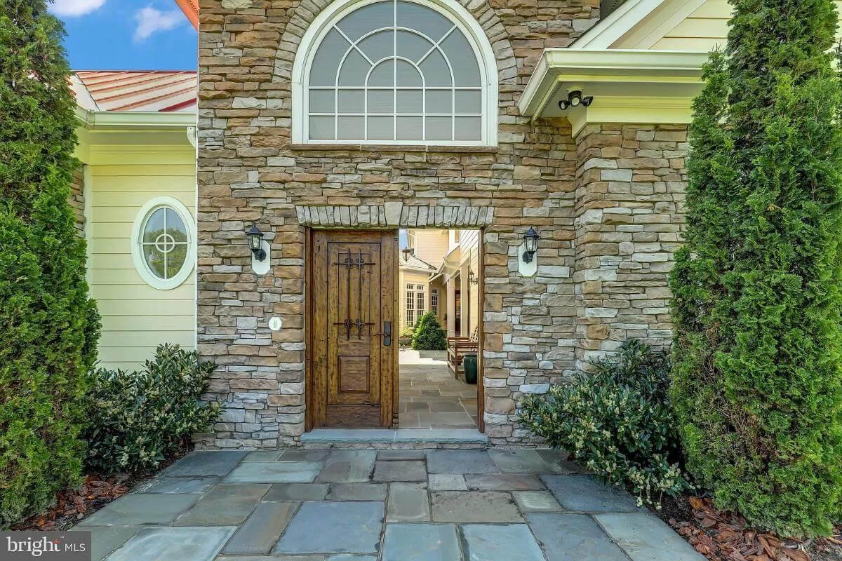 Notice the Arched Window Above This Stone-Clad Entryway