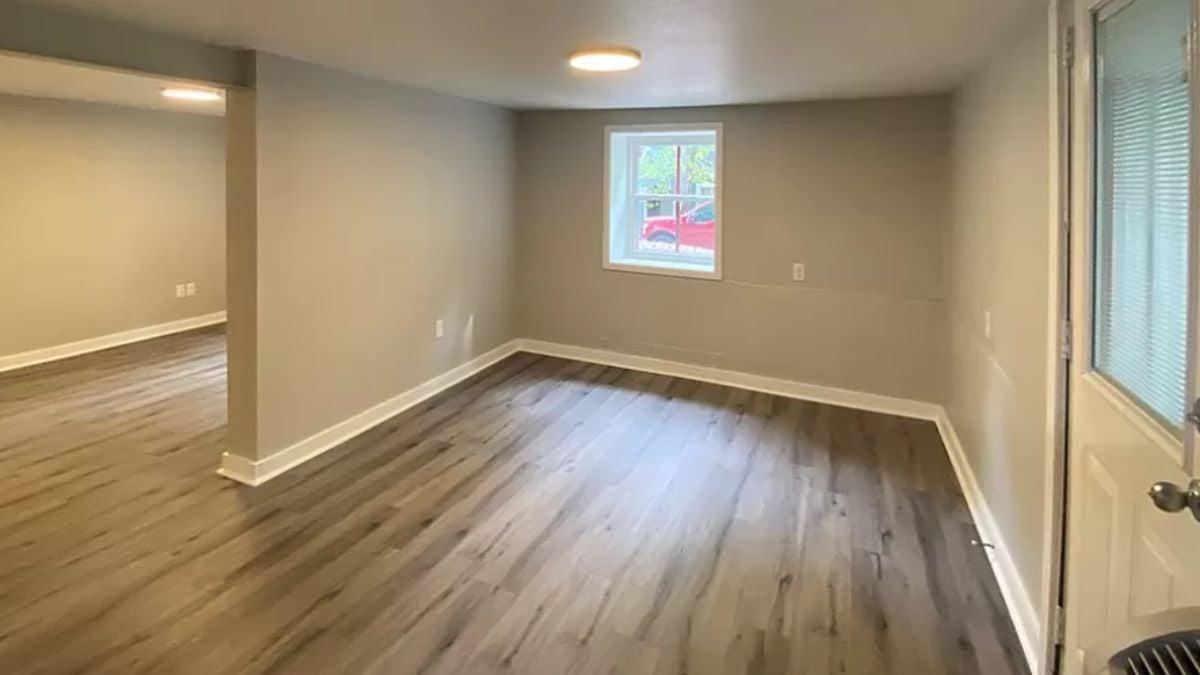 Versatile Space in the Basement With Warm Wood Flooring