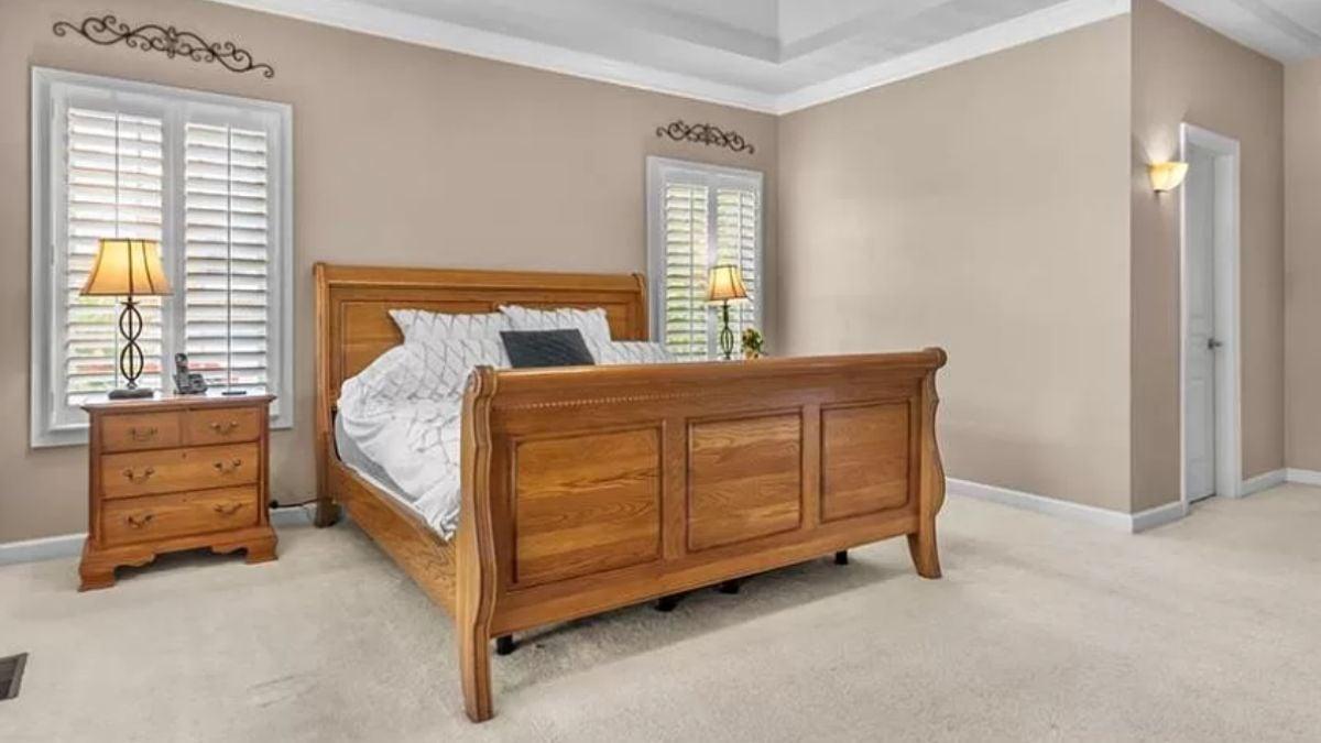 Notice the Tray Ceiling and Classic Wooden Bed in This Bedroom